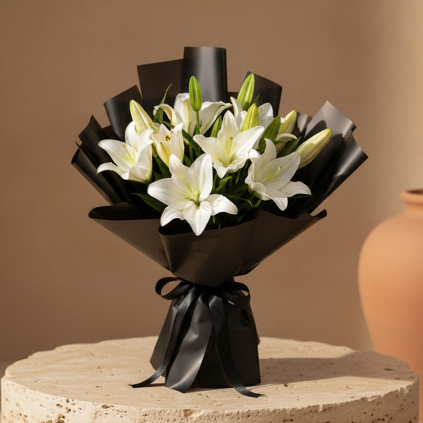 Lilianna hand-tied bouquet with 10 white lilies in black wrapping by Aiwa Flowers