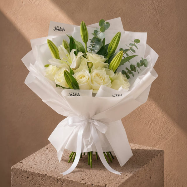 White rose and lily bouquet in white wrap by AIWA Flowers Dubai