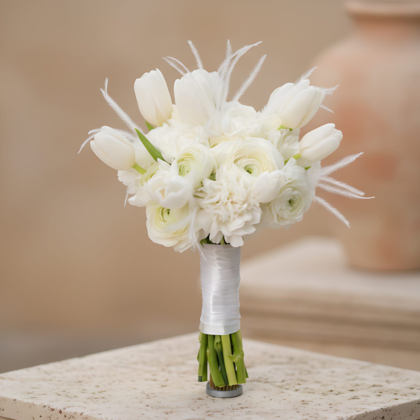 Lullaby bridal bouquet with white ranunculus, carnations, tulips and feather accents by Aiwa Flowers