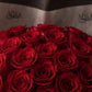 Close-up of deep red roses in the Madame bouquet, wrapped in black and white paper with the AIWA logo, by Aiwa Flowers.