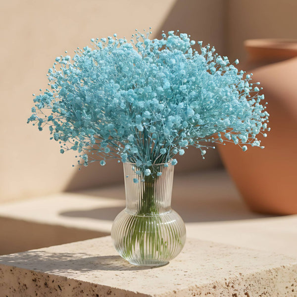 Madelyn arrangement with baby blue gypsophila in a clear glass vase