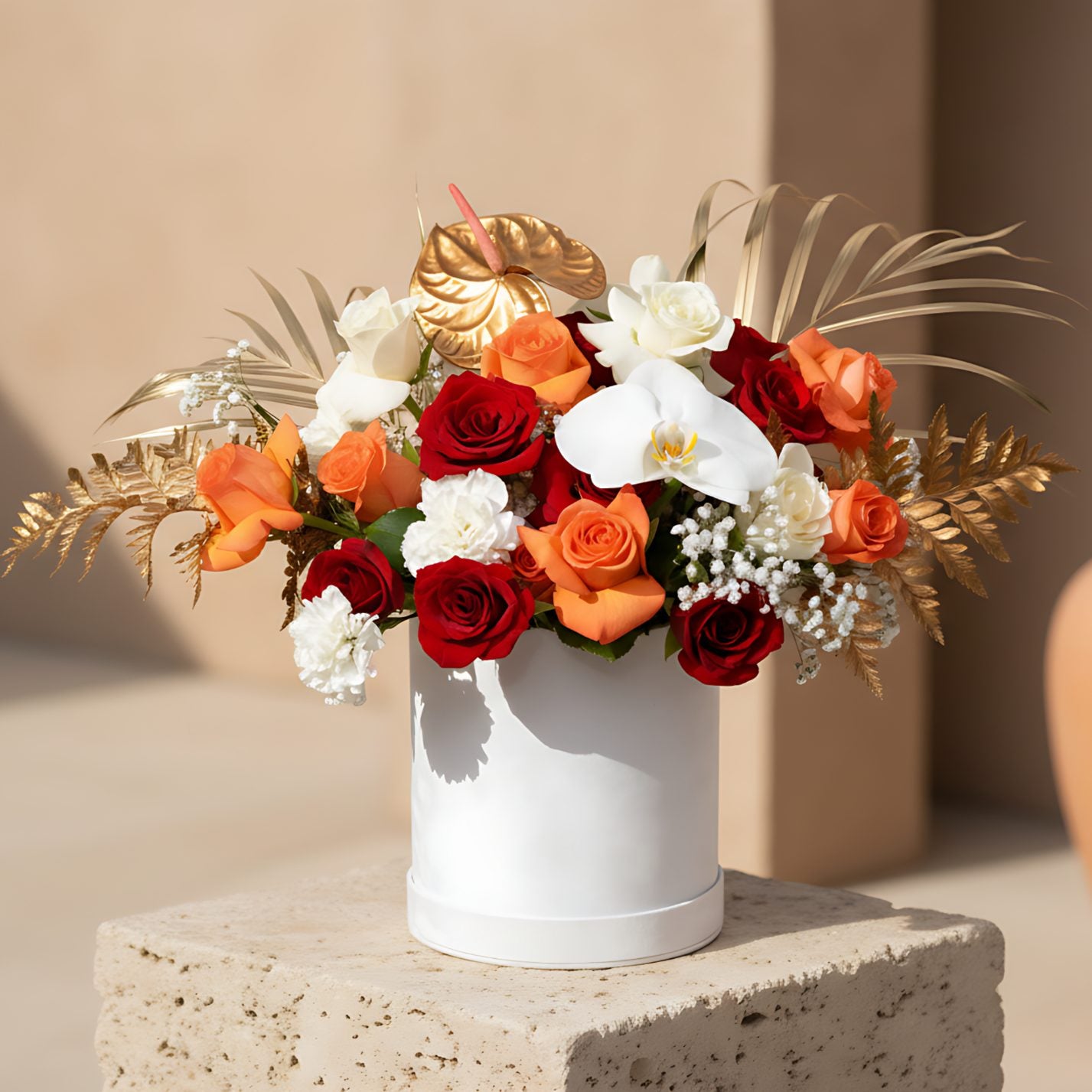 Mist white velvet flower box with white, red and orange roses, white carnations, orchid and gold accents