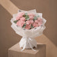 Moments with Her pink carnation bouquet in white wrapping on a plinth by AIWA Flowers