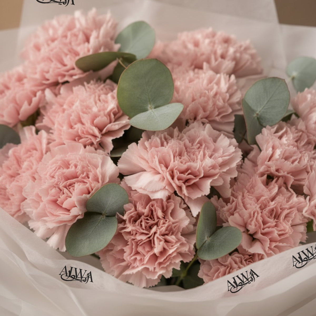 Close-up of blush pink carnations with silver eucalyptus by AIWA Flowers