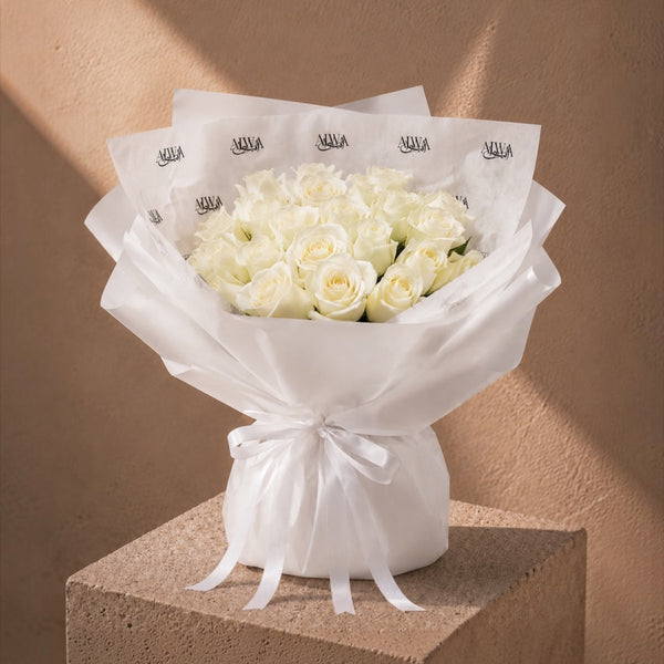 Bouquet of white roses in white AIWA wrapping with a satin ribbon - Niveous White by AIWA Flowers