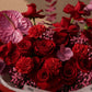 Close-up of red roses, red carnations and pink gypsophila by AIWA Flowers