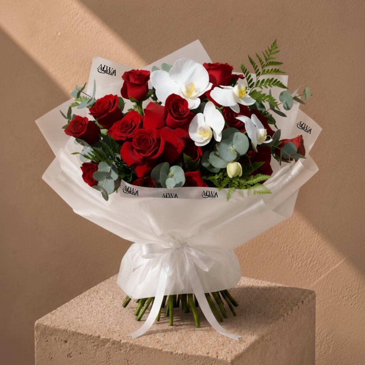 Orchid Ballet red rose and white orchid bouquet in white wrapping by AIWA Flowers