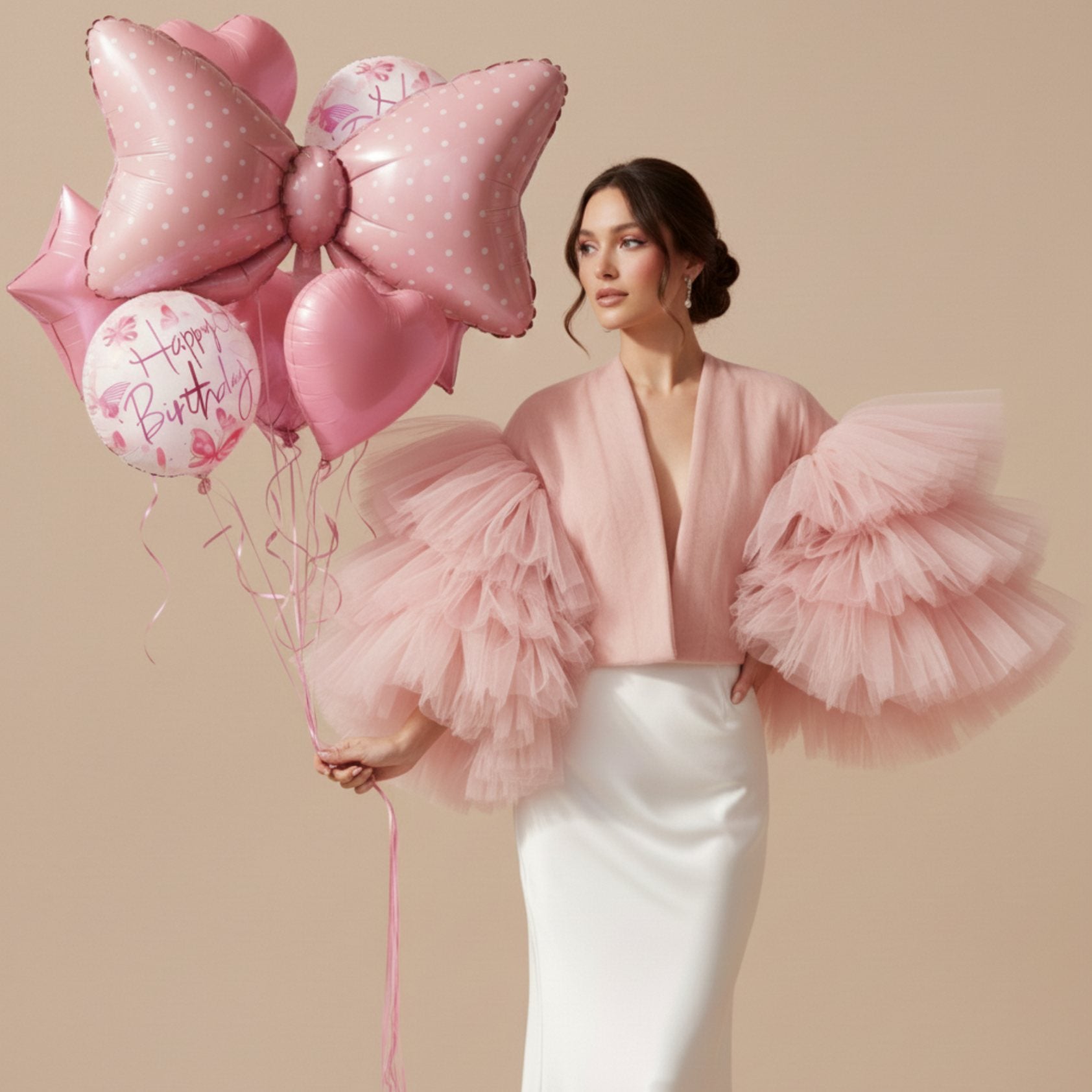 pink bow helium birthday balloon bouquet held by model