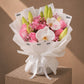 Pink Dreams pink rose, lily and white orchid bouquet in white wrapping by AIWA Flowers