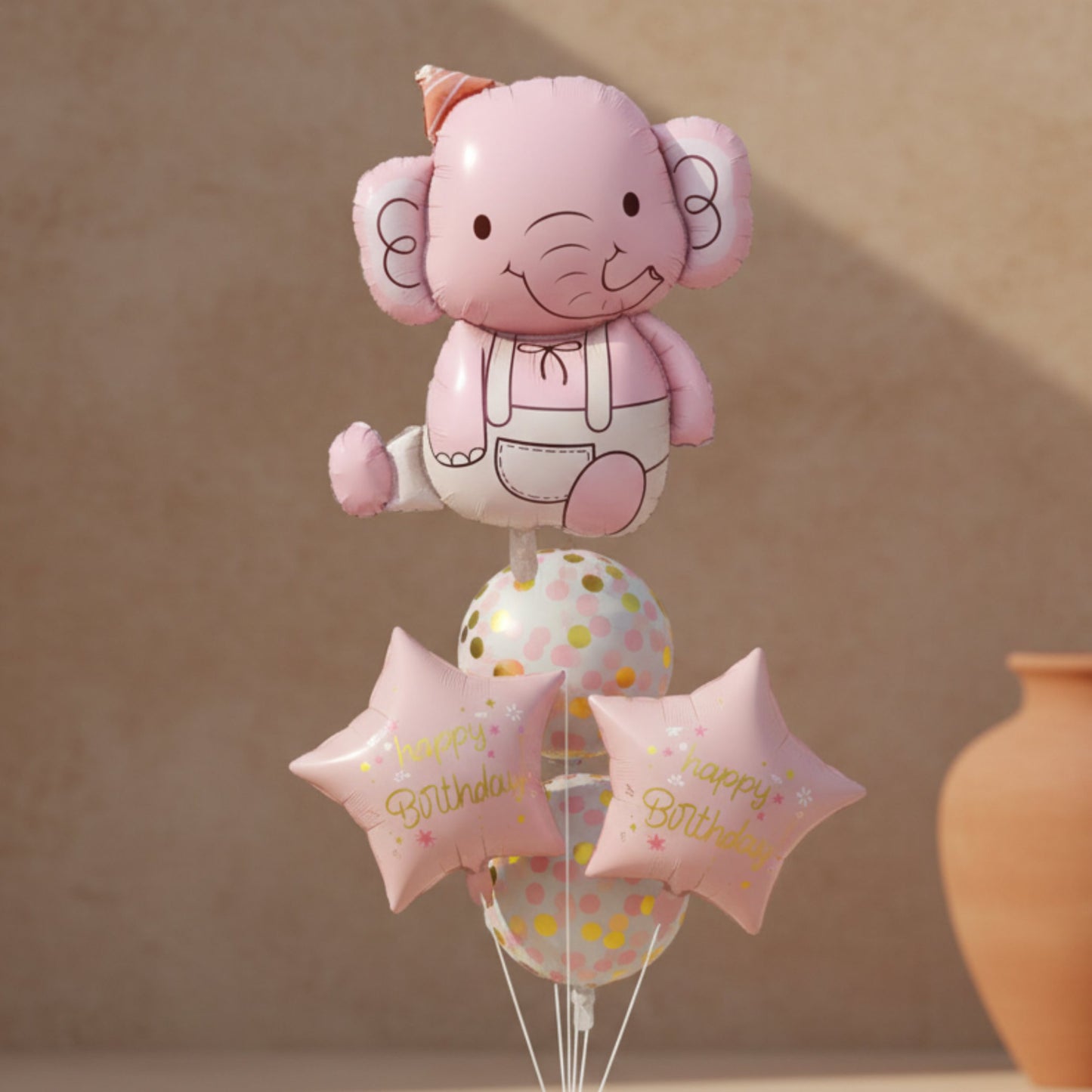 Pink elephant foil balloon with pastel confetti balloons and happy birthday star balloons