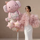 Pink elephant birthday helium balloon set with confetti balloons and happy birthday star balloons held by model
