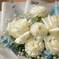 Close-up of white roses and carnations with blue-tinted eucalyptus by AIWA Flowers