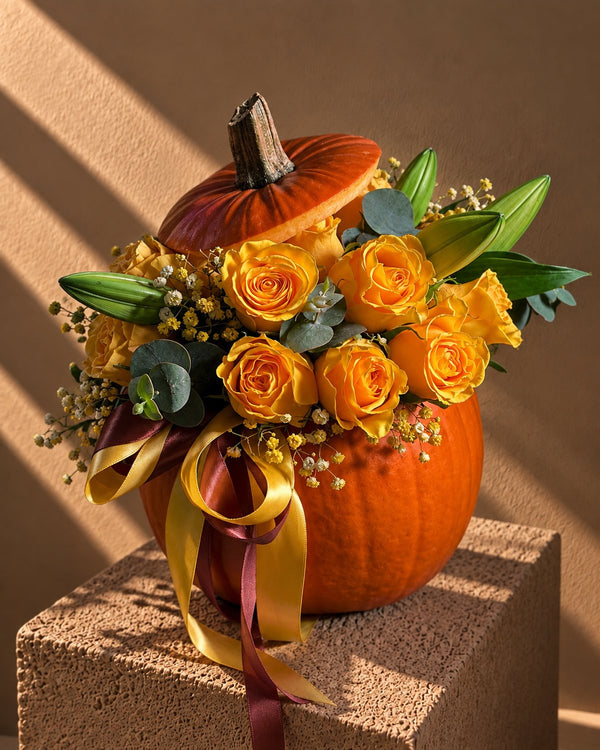 Pumpkin Stealer Halloween arrangement of orange roses in a fresh pumpkin with its lid tipped open