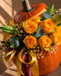 Close-up of orange roses, lily stems and yellow gypsophila in Pumpkin Stealer