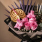 Close-up of pink roses, gold anthurium and purple palm by AIWA Flowers