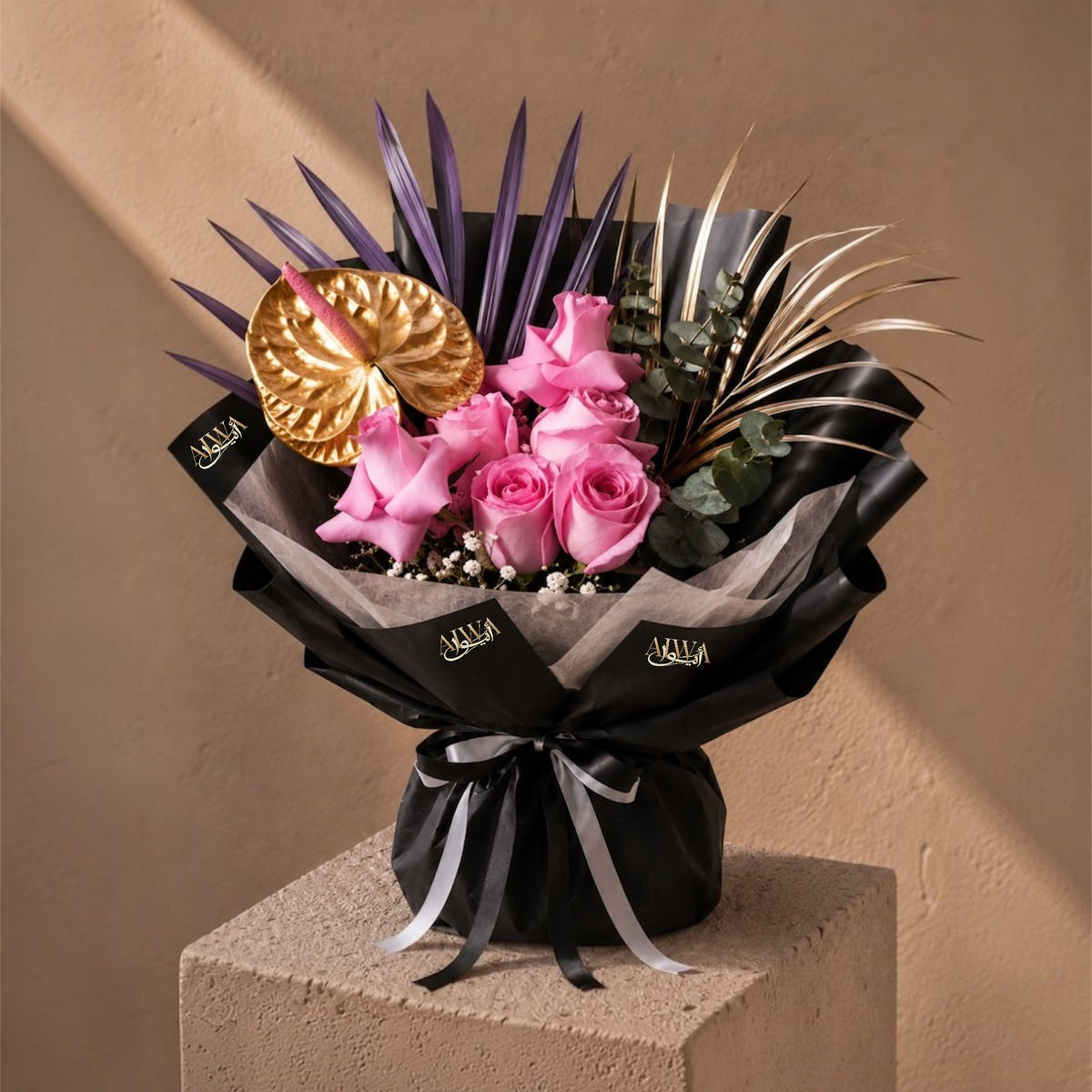 Pink roses with a gold anthurium and purple palm spears in black wrap - Purple Crush by AIWA Flowers