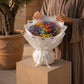 Woman holding a multicolour rainbow gypsophila bouquet in white wrap - Rainbow by AIWA Flowers