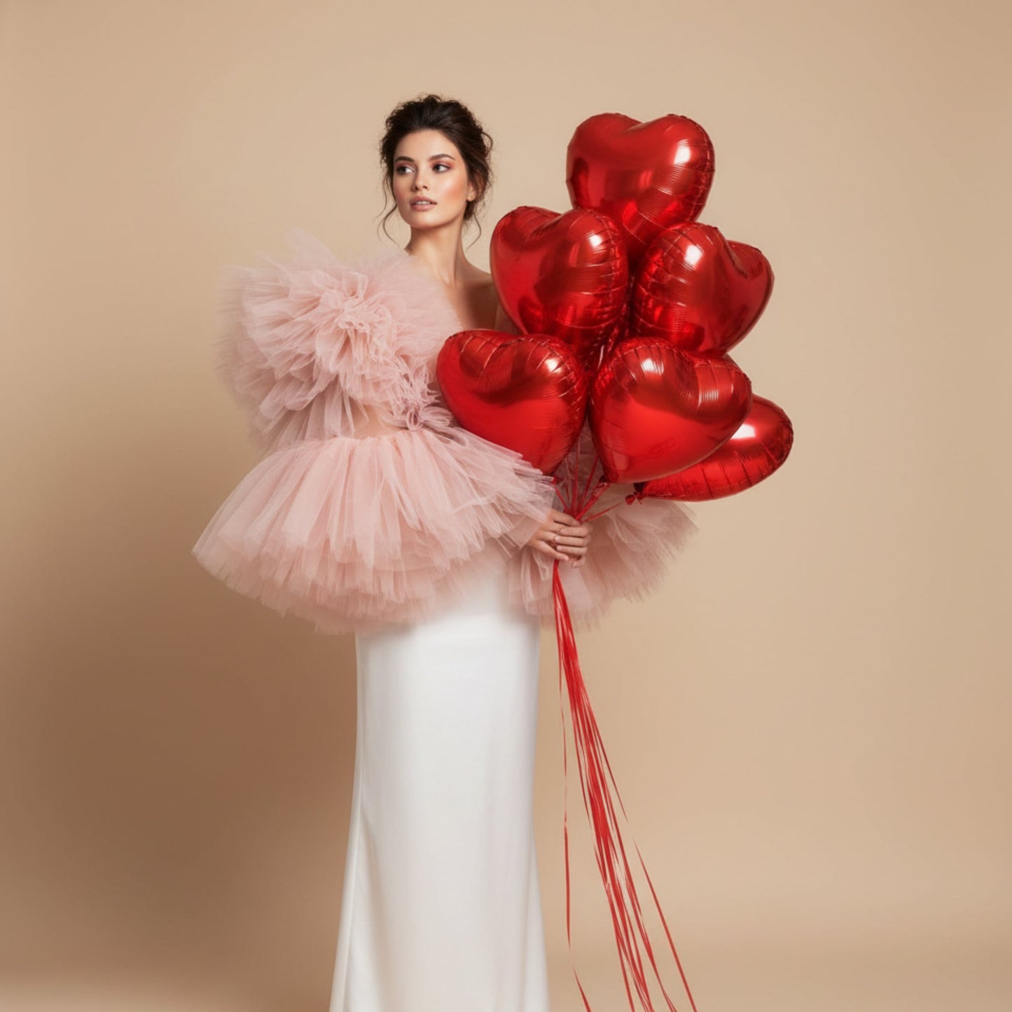 model holding red heart balloon bouquet