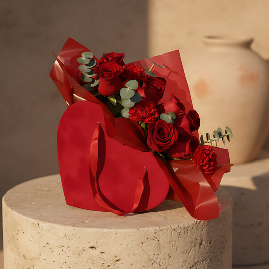 Romantica red velvet heart box with red roses, red carnations and eucalyptus