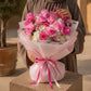 Woman holding a pink rose and white hydrangea bouquet in pink wrap - Rose Amour by AIWA Flowers