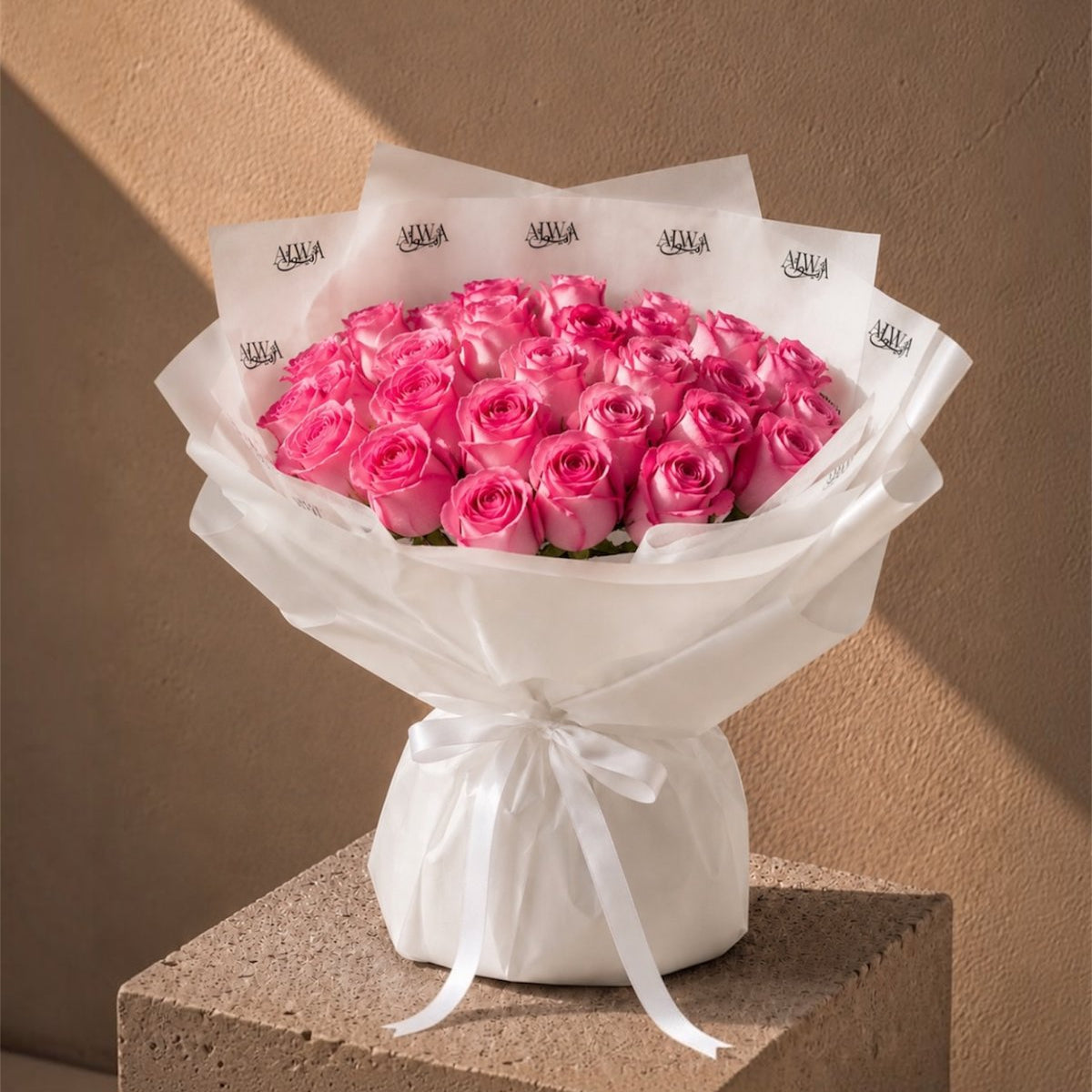Bouquet of vibrant pink roses in white AIWA wrapping - Rose Gelato by AIWA Flowers