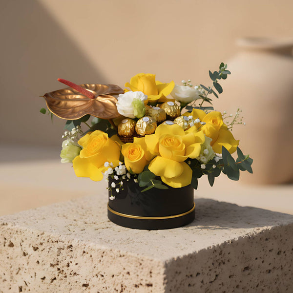 Sadaqah black round flower box with yellow roses, lisianthus, gold anthurium and Ferrero Rocher chocolate