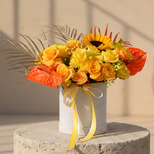Saffron white velvet flower box with yellow and orange roses, sunflower, anthuriums and gypsophila