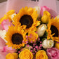 Close-up of sunflowers, pink, yellow and white roses with pink gypsophila - Serenity by AIWA Flowers