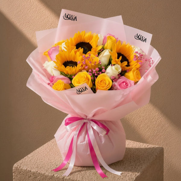 Sunflower, yellow and pink rose bouquet in pink wrap on a pedestal - Serenity by AIWA Flowers