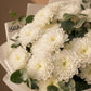 Close-up of white chrysanthemum blooms by AIWA Flowers Dubai