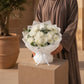 Woman holding a white chrysanthemum bouquet by AIWA Flowers Dubai