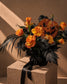 Spooky Spell Halloween bouquet of orange roses and black carnations with a jack-o'-lantern pick