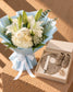Spring Fling white lilies and hydrangea bouquet in baby-blue wrap with a baby boy gift box by AIWA Flowers Dubai