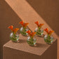 Five Stella orange calla lily clear glass bud vases styled on a plinth by AIWA Flowers