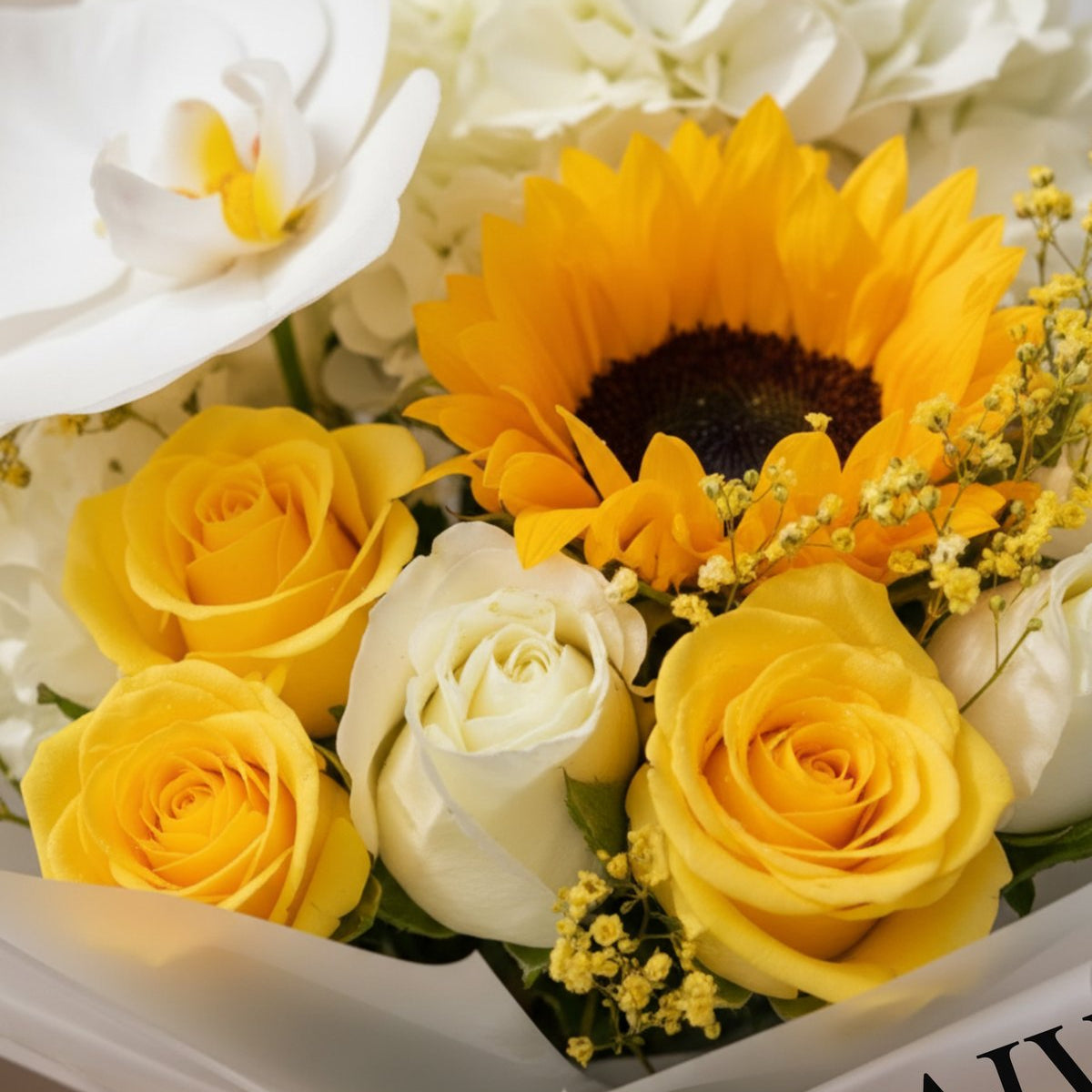 Close-up of sunflower, white orchid and yellow roses in Summer Meadow bouquet by AIWA Flowers