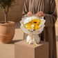 Woman holding sunny Summer Meadow bouquet with sunflower and yellow roses - AIWA Flowers Dubai