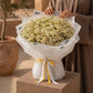 Woman holding a white daisy bouquet by AIWA Flowers Dubai