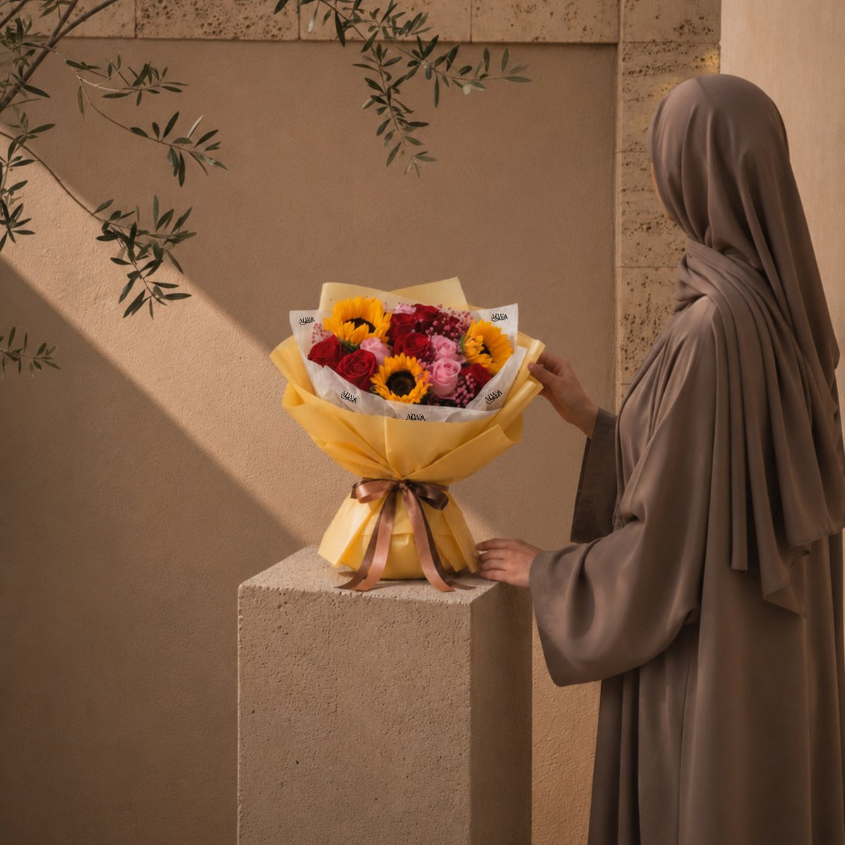 Woman holding a sunflower, red and pink rose bouquet in gold wrap - Sunflower Blossoms by AIWA Flowers