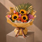 Sunflowers with orange and pink roses and gold accents in gold wrap - Sunflowers Dream by AIWA Flowers