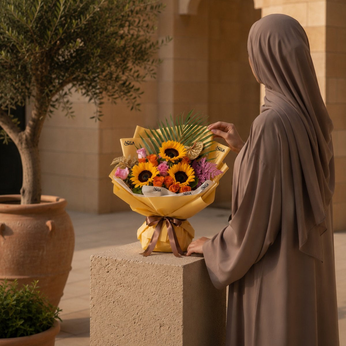 Woman holding sunflower and rose bouquet in gold wrap - Sunflowers Dream by AIWA Flowers