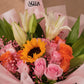 Close-up of Sunlover bouquet: sunflower, white lilies, pink and orange roses with gypsophila - AIWA Flowers