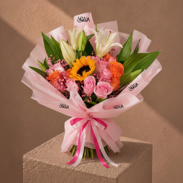 Sunlover bouquet of sunflower, lilies, pink and orange roses in pink wrap on a pedestal - AIWA Flowers