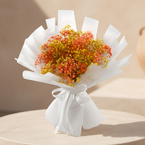 Sunny hand-tied bouquet of orange and yellow gypsophila in white wrapping by Aiwa Flowers
