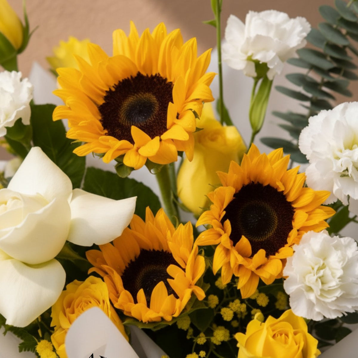 Close-up of sunflowers, white roses and carnations in the Sunrise bouquet by AIWA Flowers