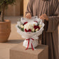 Woman holding Swan bouquet of white hydrangea, orchid and red & white roses - AIWA Flowers