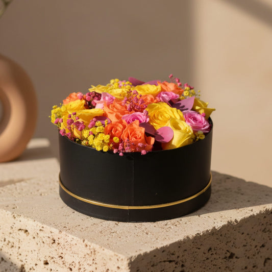 Tangerine black flower box with yellow, pink and orange roses, gypsophila and pink eucalyptus