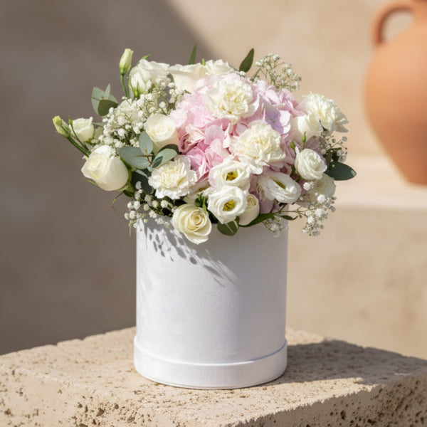 Tchaikovsky flower box with white roses, pink hydrangea, white carnations and gypsophila in a white velvet box