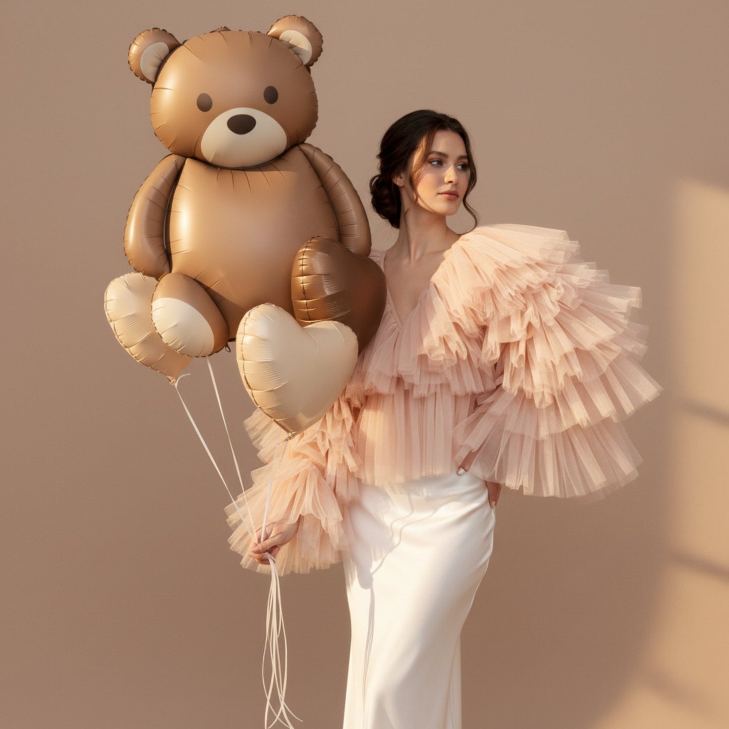 teddy bear helium balloon bouquet with heart balloons held by model