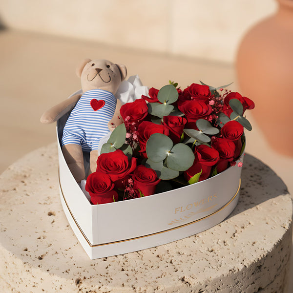 Teddy’s Heart flower box with red roses, eucalyptus and a teddy bear in a white heart box