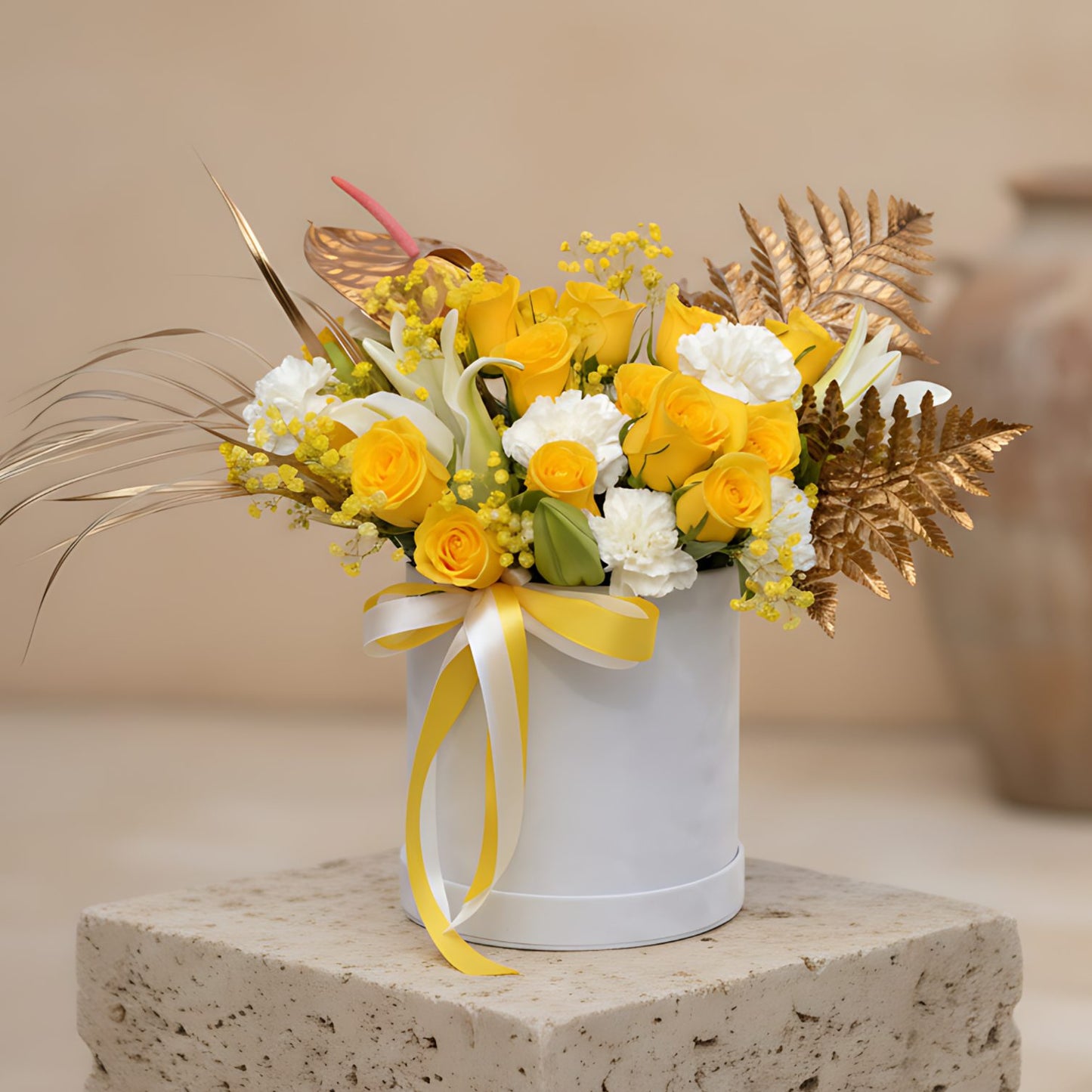 Timeless flower box with yellow roses, white carnations, lilies and gold accents in a white velvet box